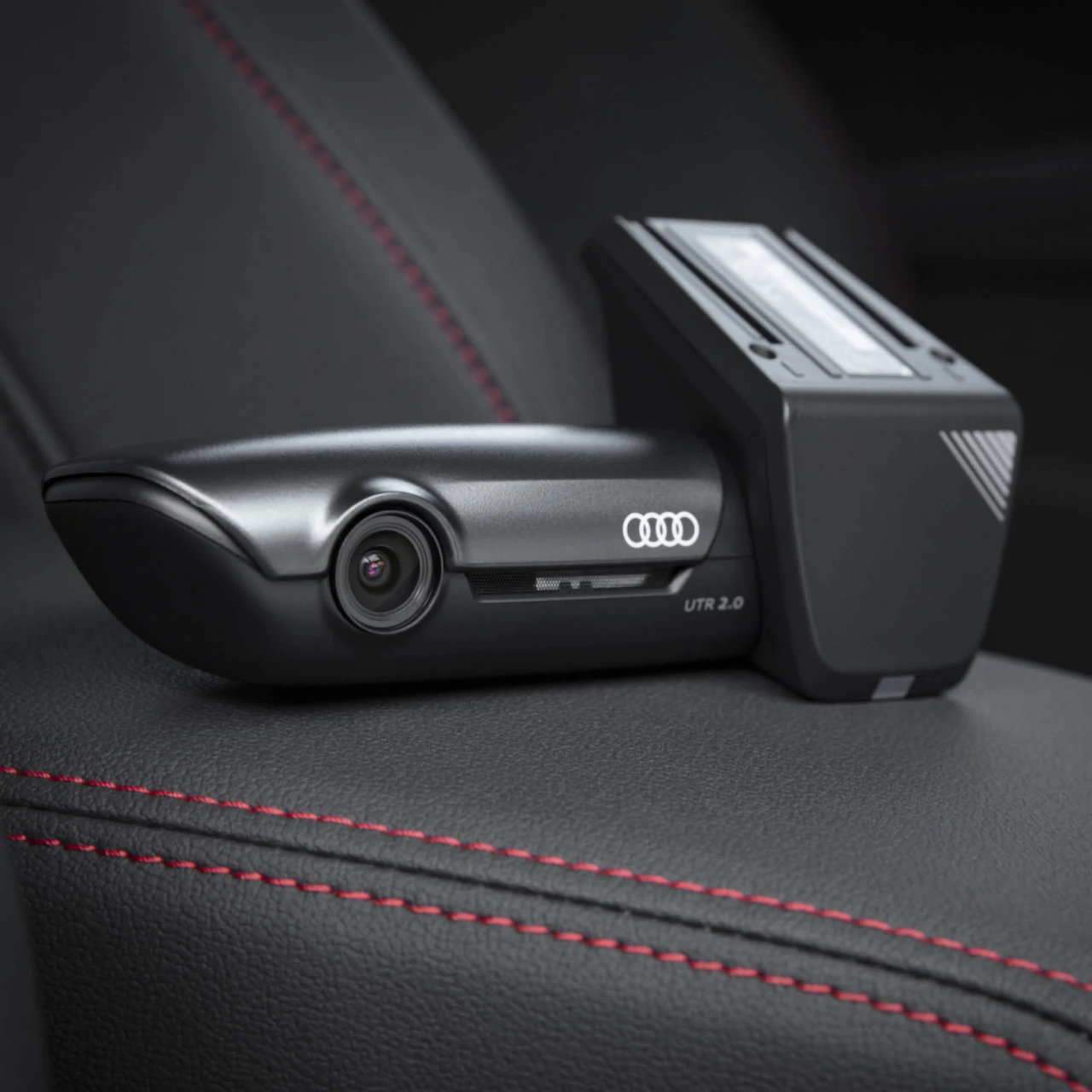 Front Audi dash cam on black leather seats with red stitching