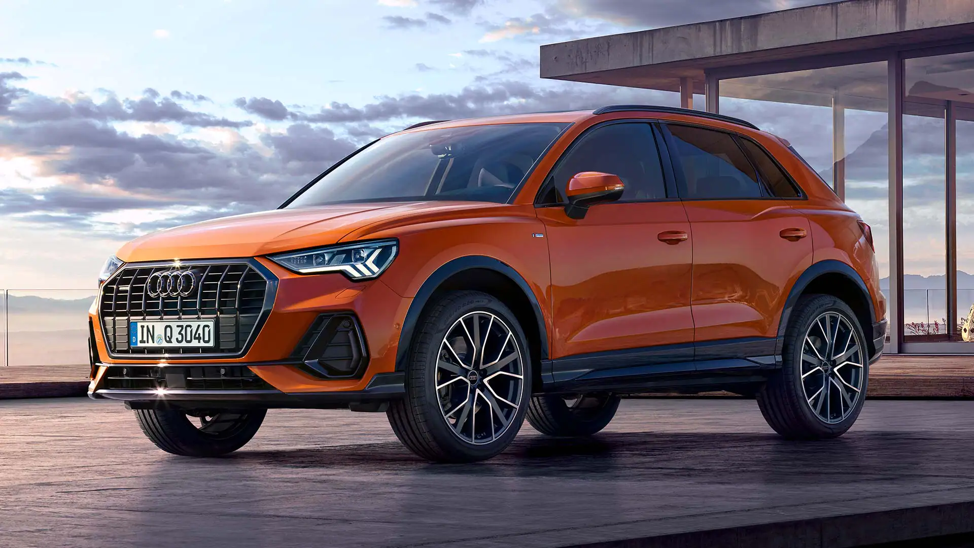 front side view of an orange audi q3