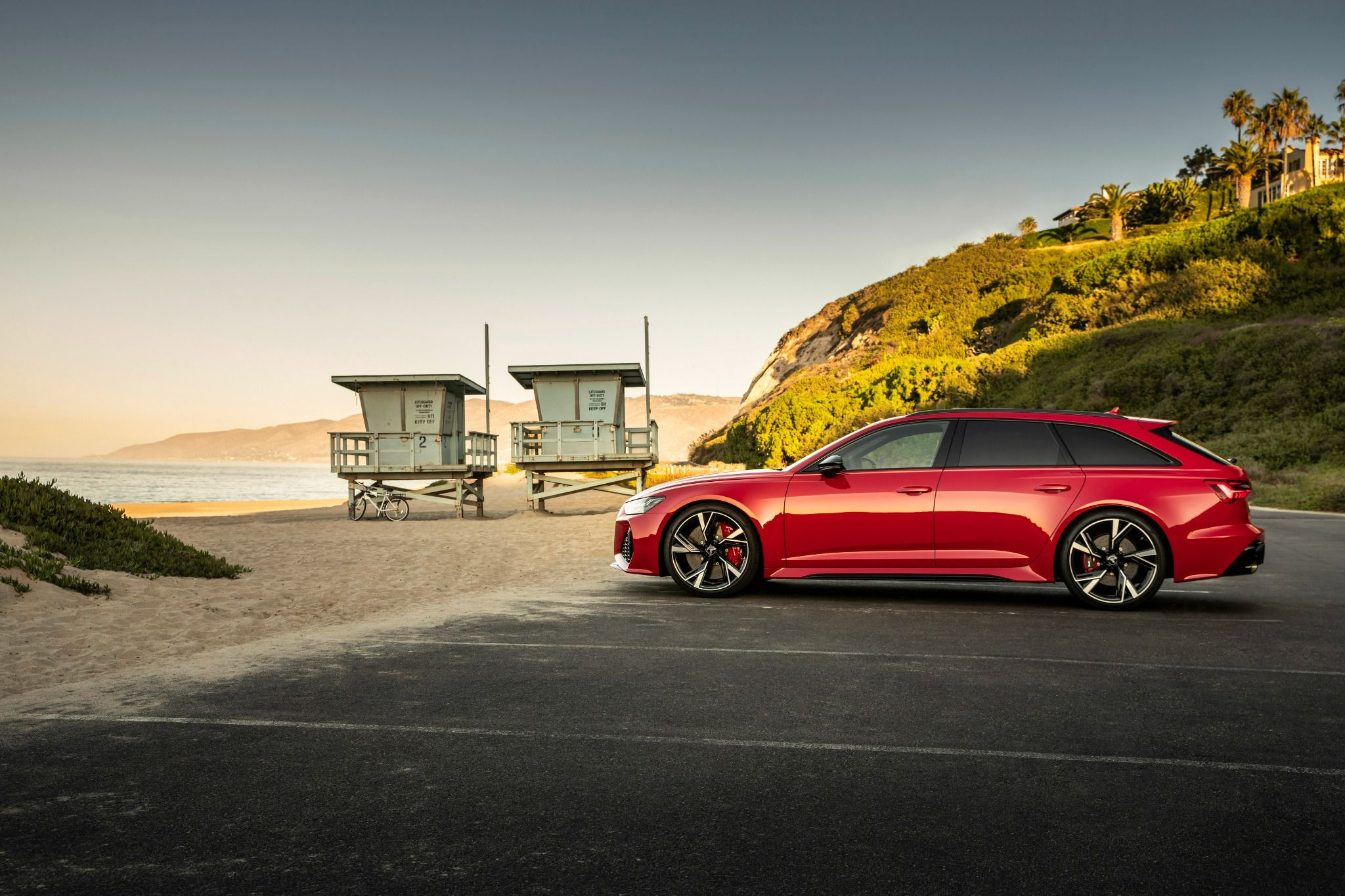Audi rs6 parked sideways in front of a beach