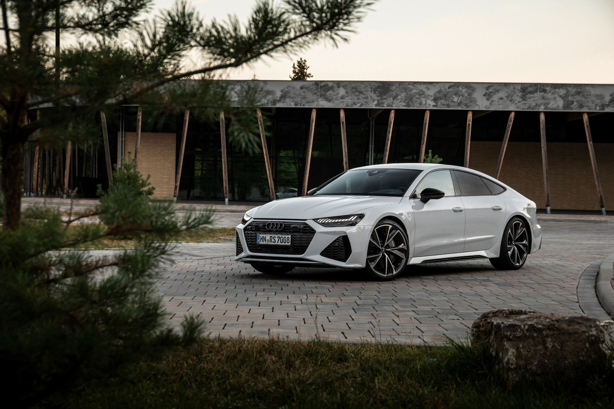 White Audi RS7 parked on a gravel path