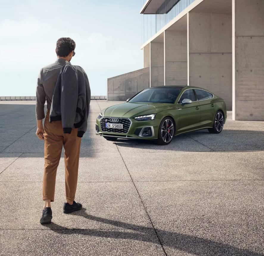 audi s5 oarked with man walking to it