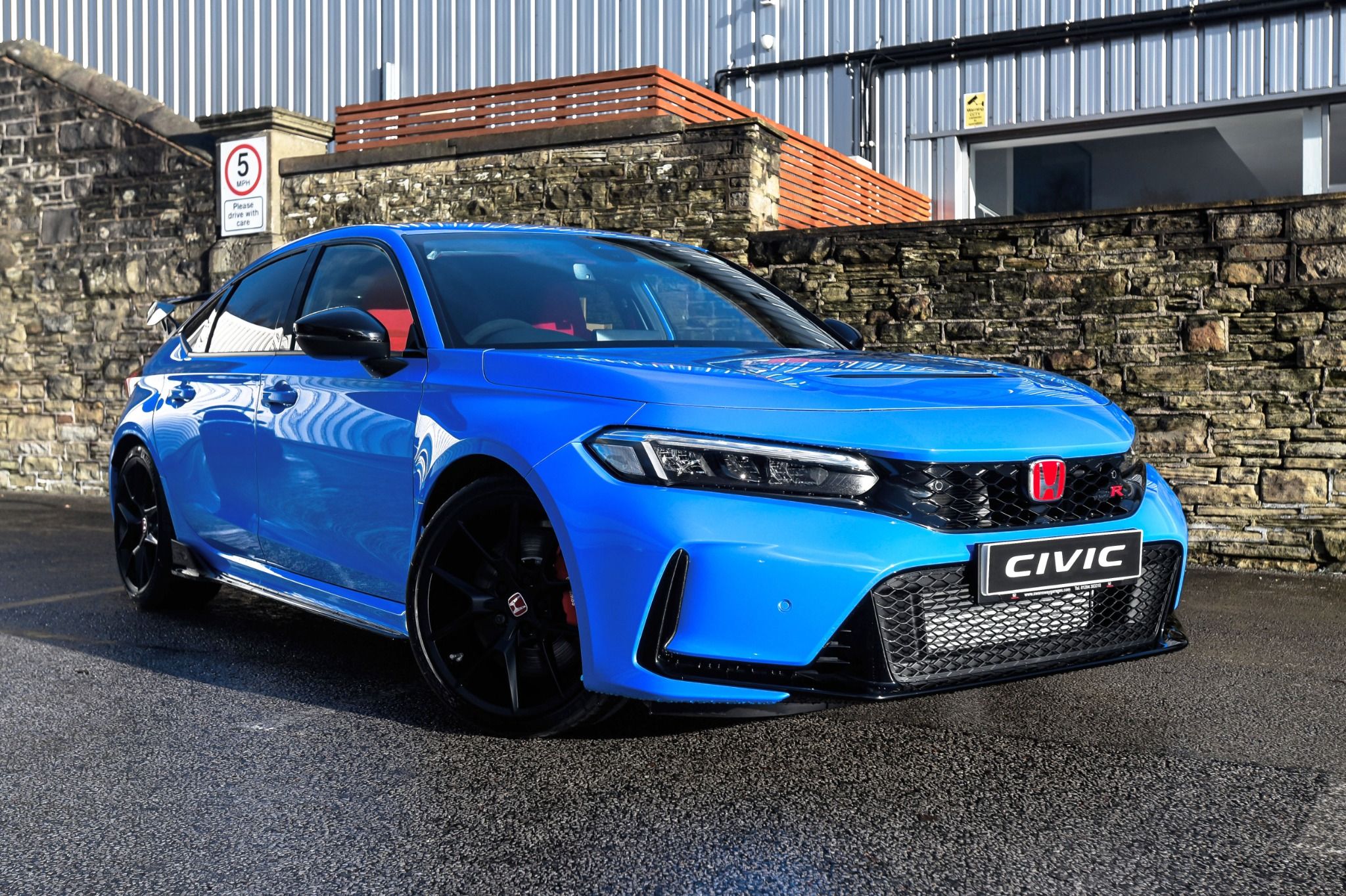 Blue Honda Civic Type R driving on the road