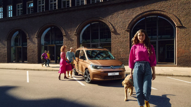 Volkswagen Caddy front with women walking with a dog