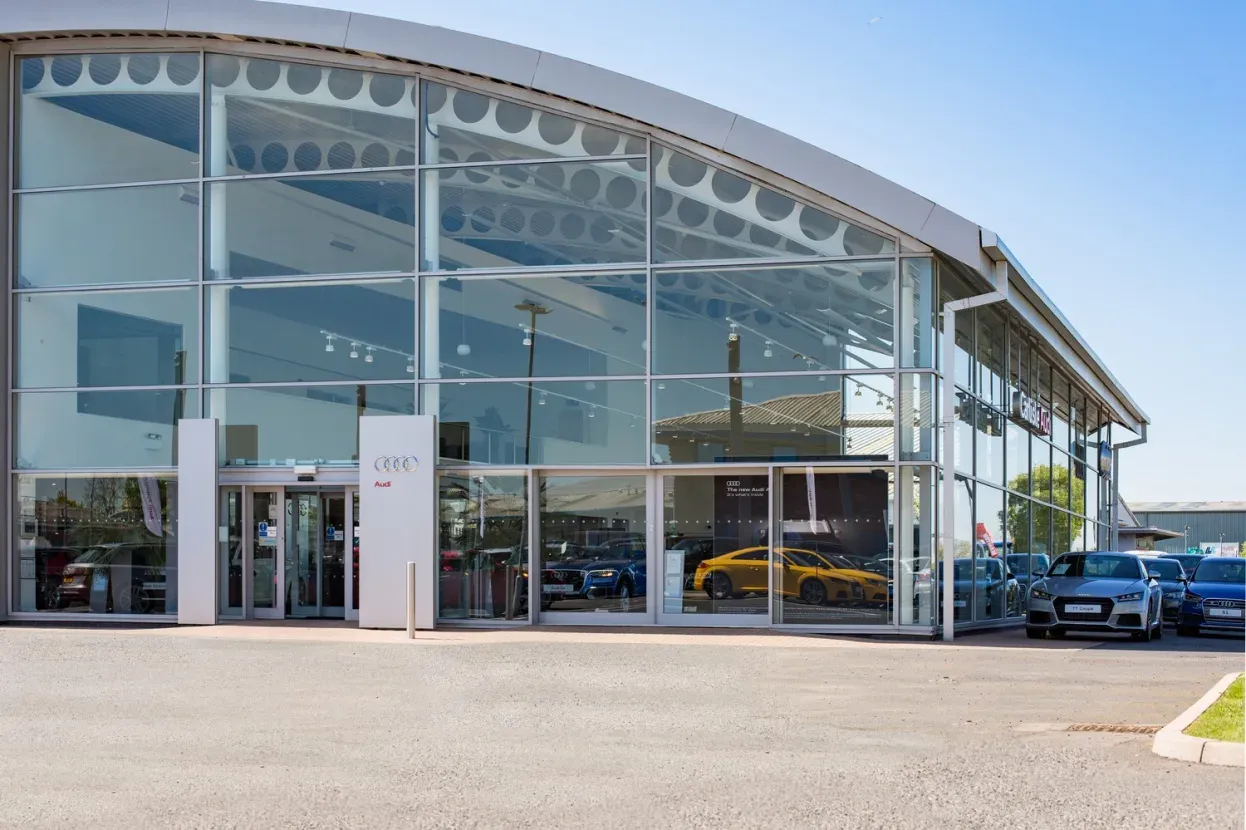 Modern glass Carlisle Audi dealership in sun