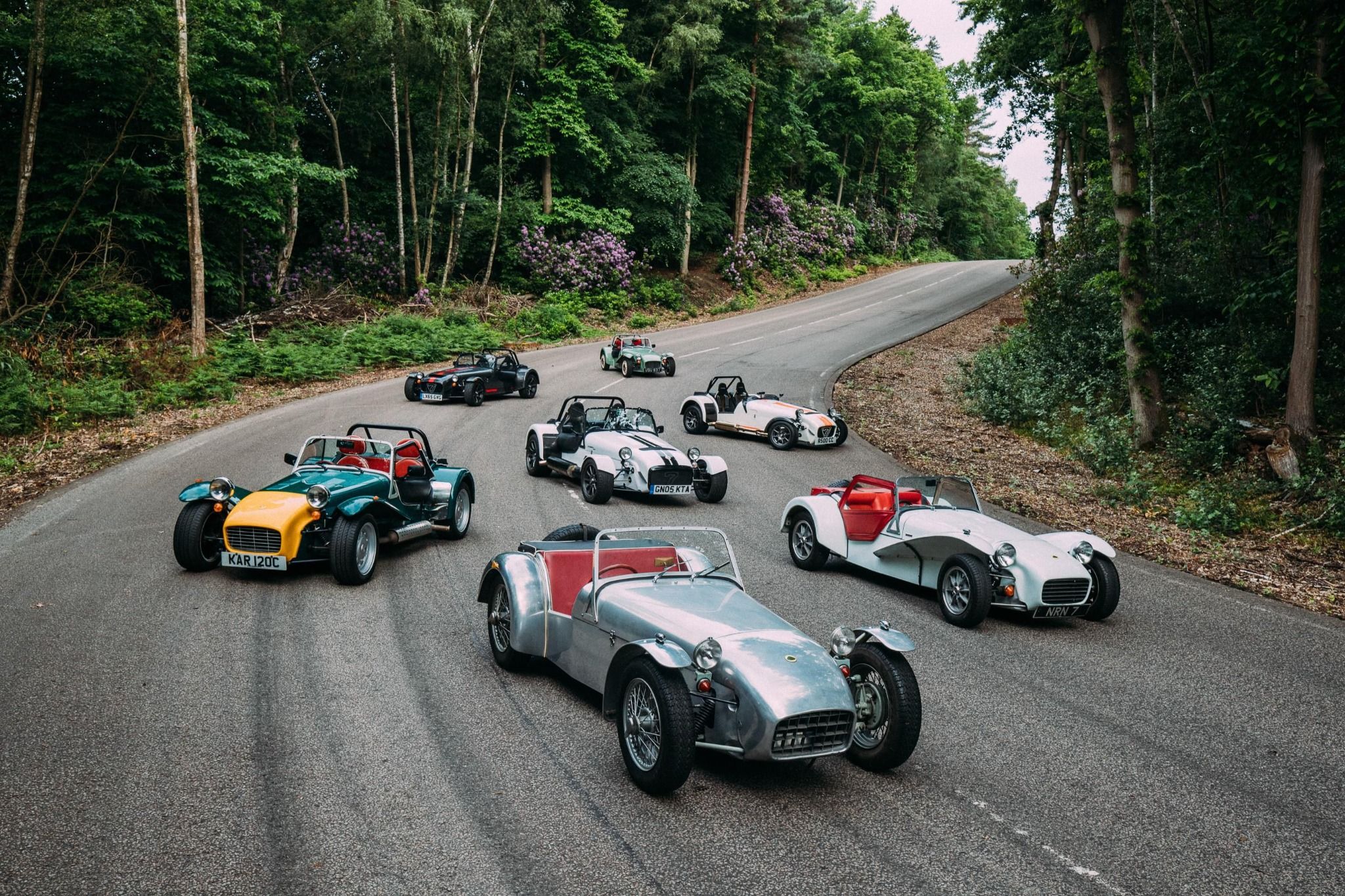 Caterham vehicles parked on a road