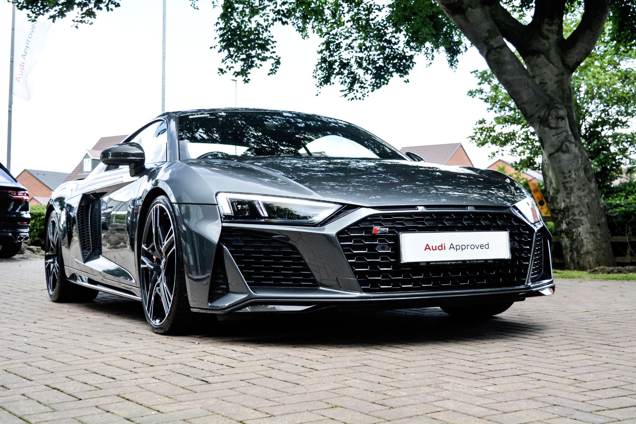 Front view of grey Audi R8 coupe with black grill