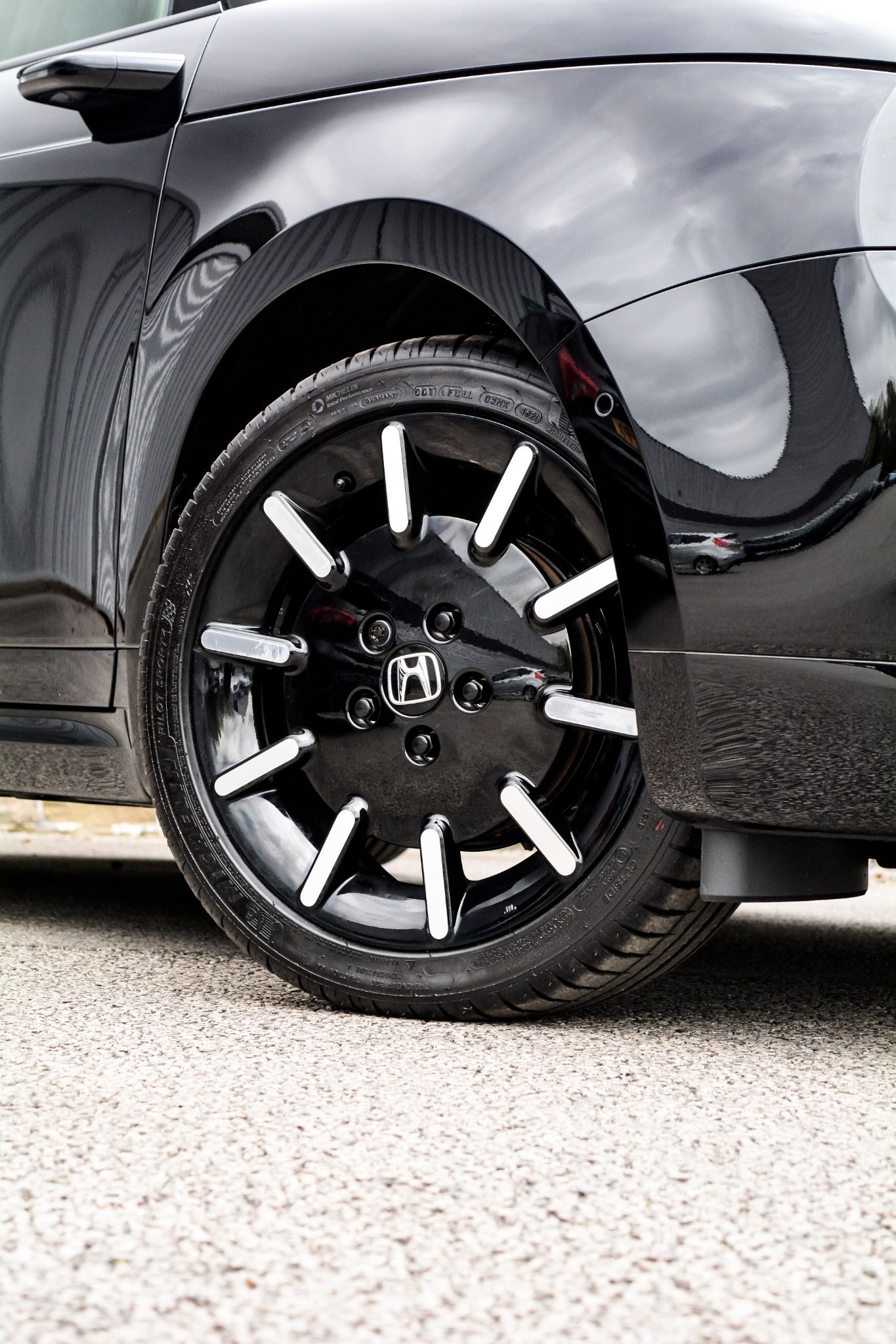 close up of  Black Honda e alloy wheels