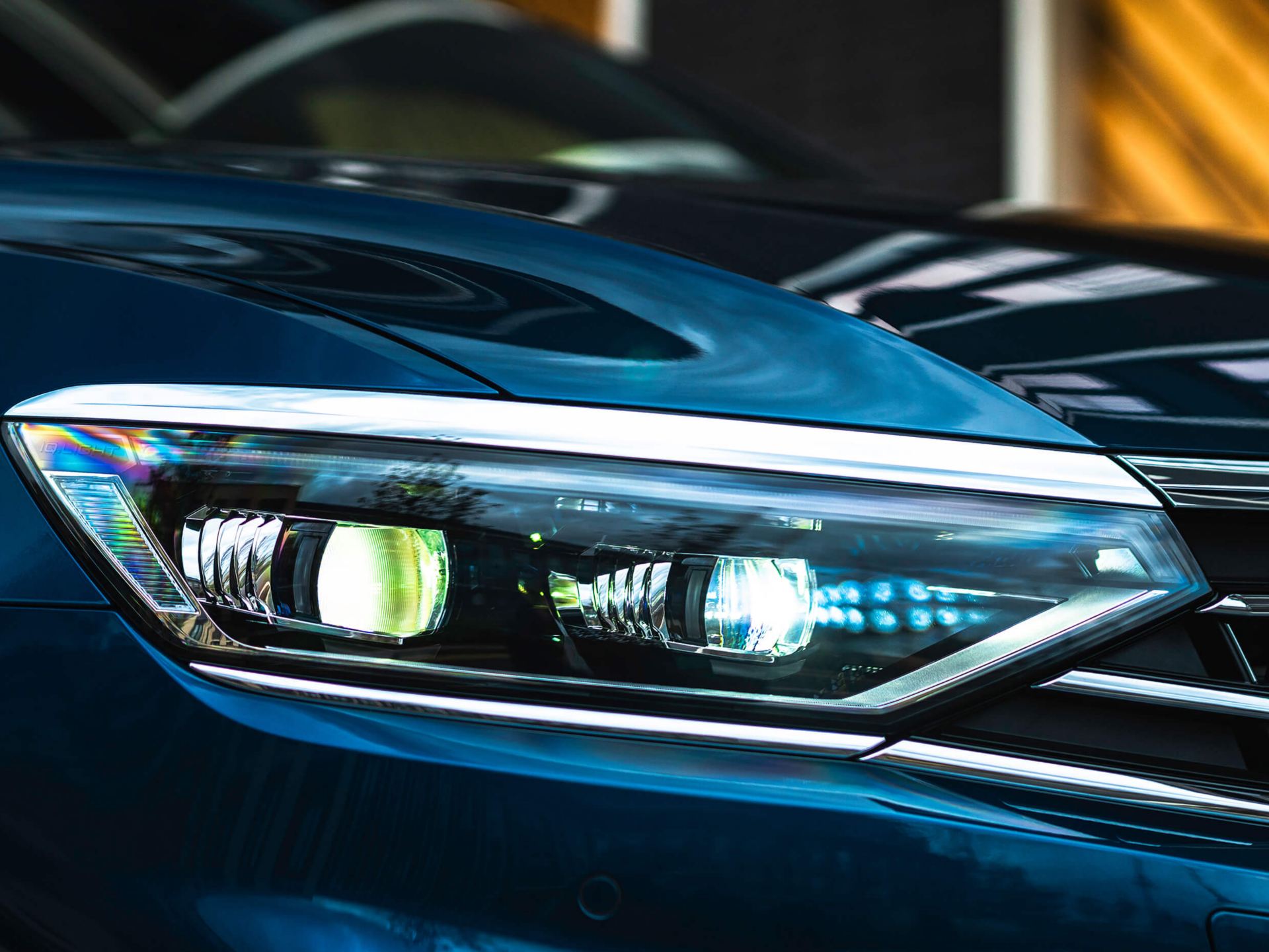 close up of blue Volkswagen Passat estate led headlights