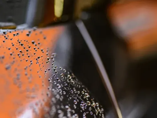 close up of water droplets on a car.