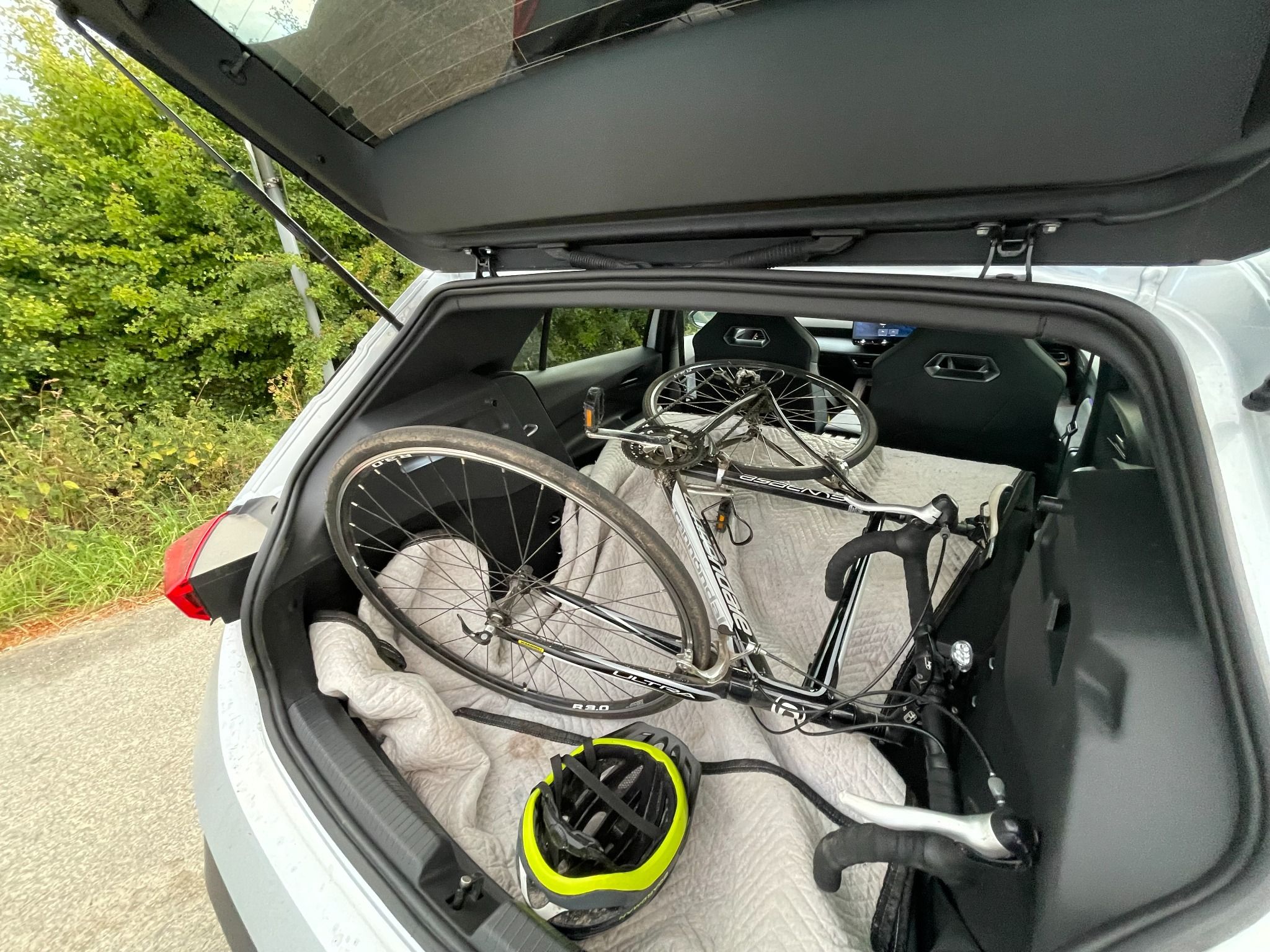 Cupra born 2 open boot with a bike placed on a blanket with the rear seat down