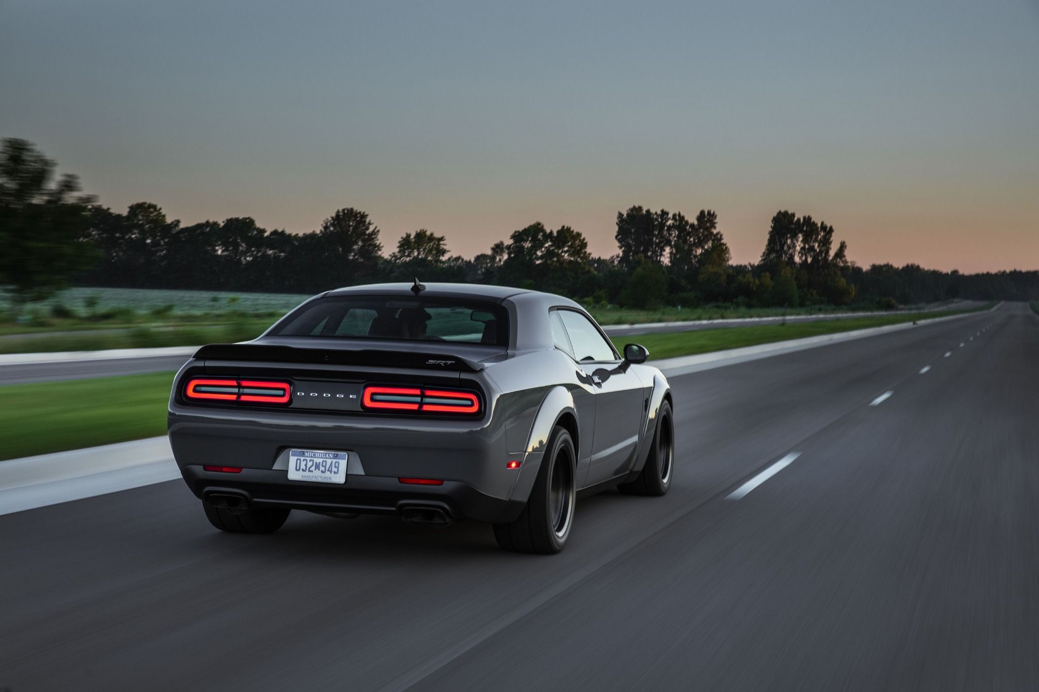 Rear view of a Dodge SRT Hellcat driving down a road