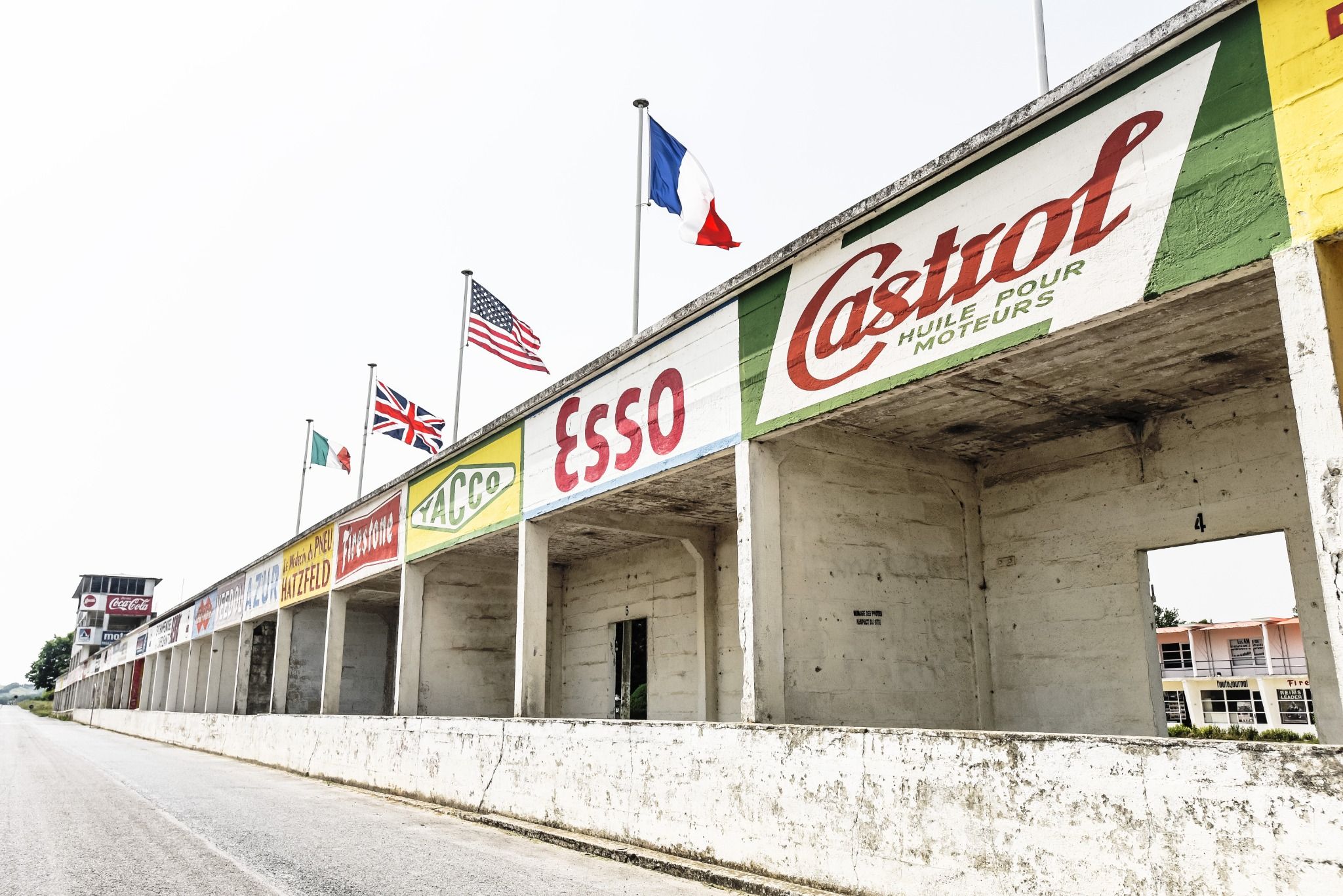 Low angle of an old race track with car brands on the side of the concrete buildings