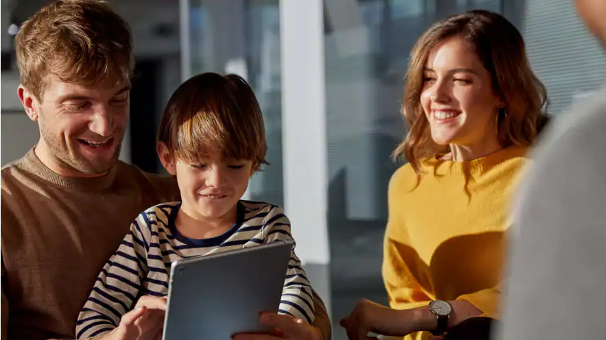 Happy family looking at tablet together