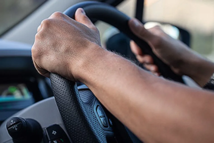 Person with hands on steering wheel