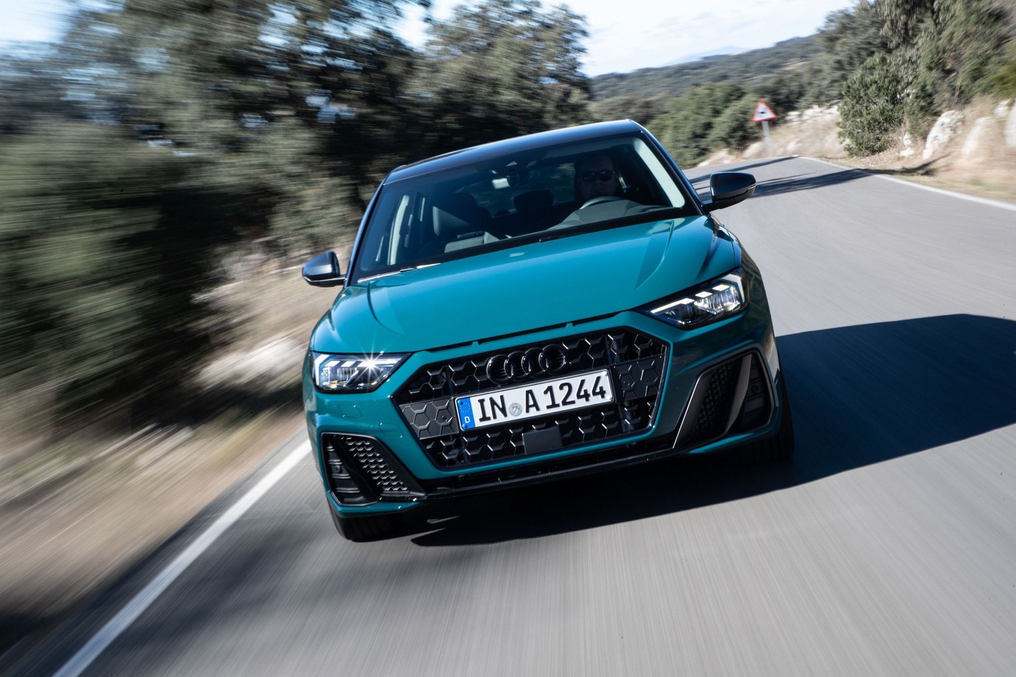 Front view of Audi A1 driving on a road