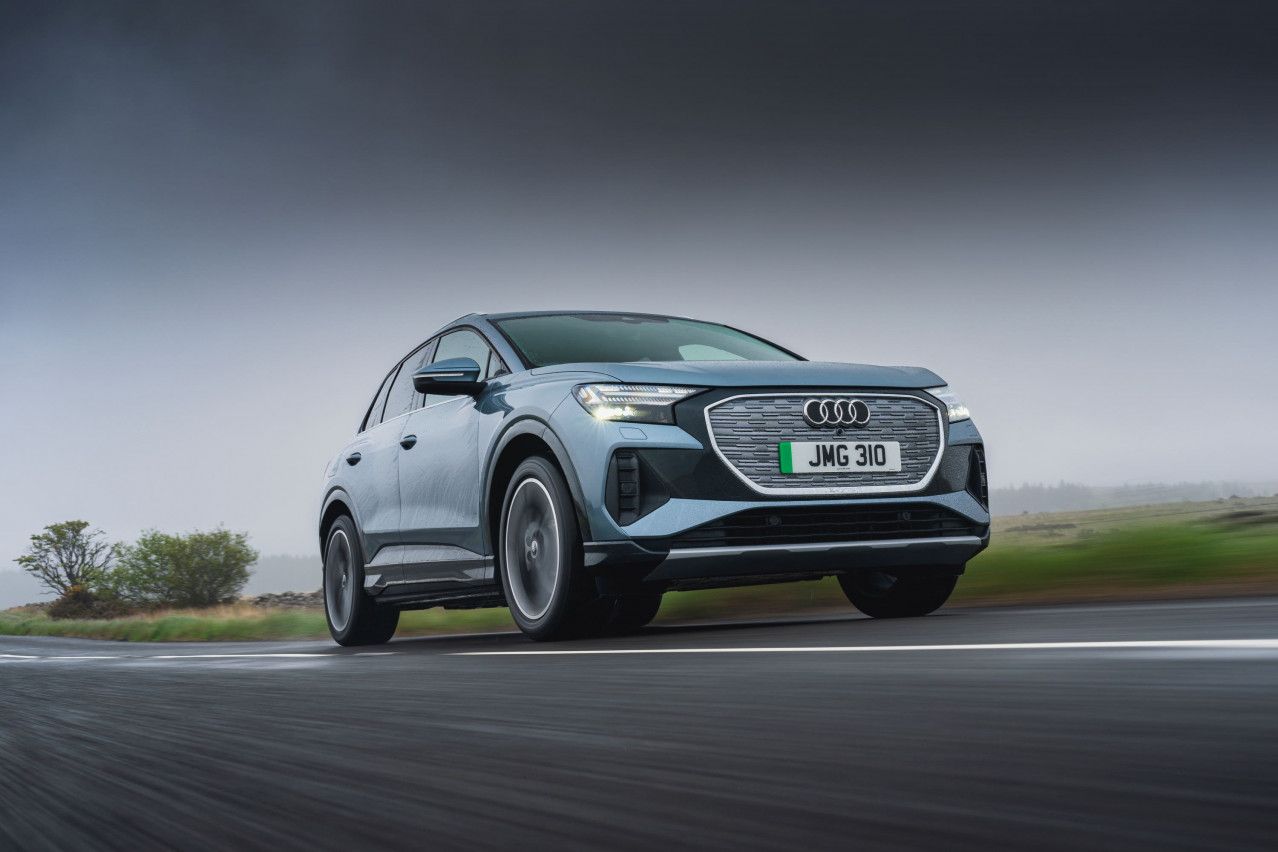 Blue silver Audi Q4 etron driving on road