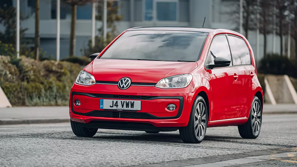 Red Volkswagen UP front driving down road