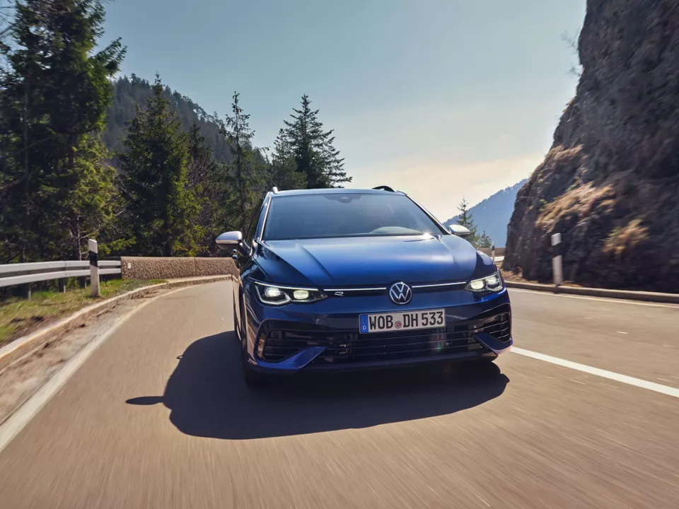 front view of vw golf r estate with mountains in the background