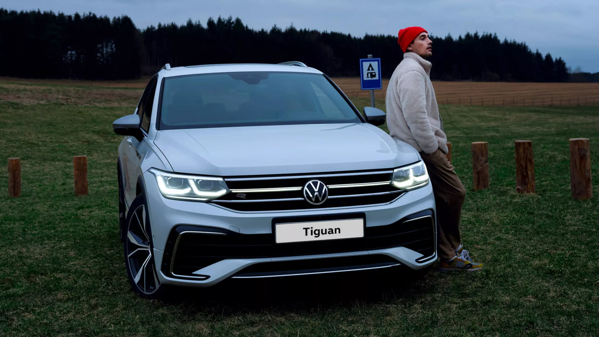 front view of vw tiguan allspace with man leaning on