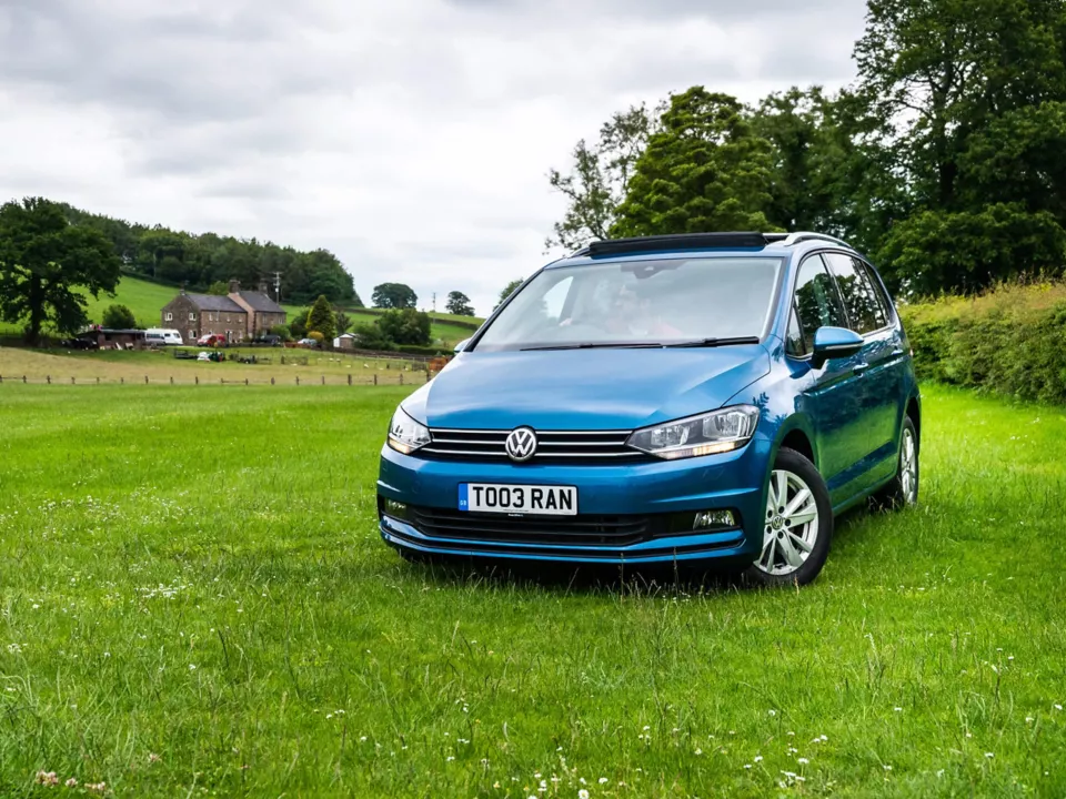 front view of vw touran parked on grass
