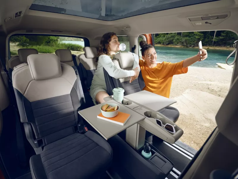 Girls taking selfie in the back seats of the Volkswagen Multivan