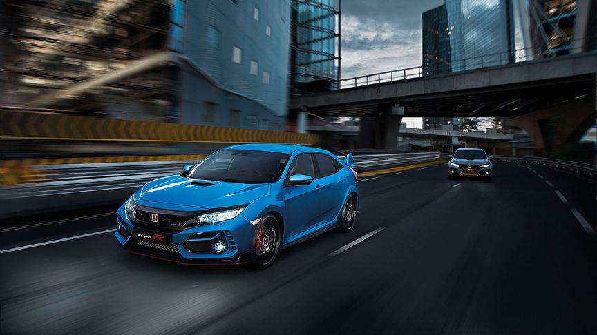 Blue Honda Civic Type R driving on a road
