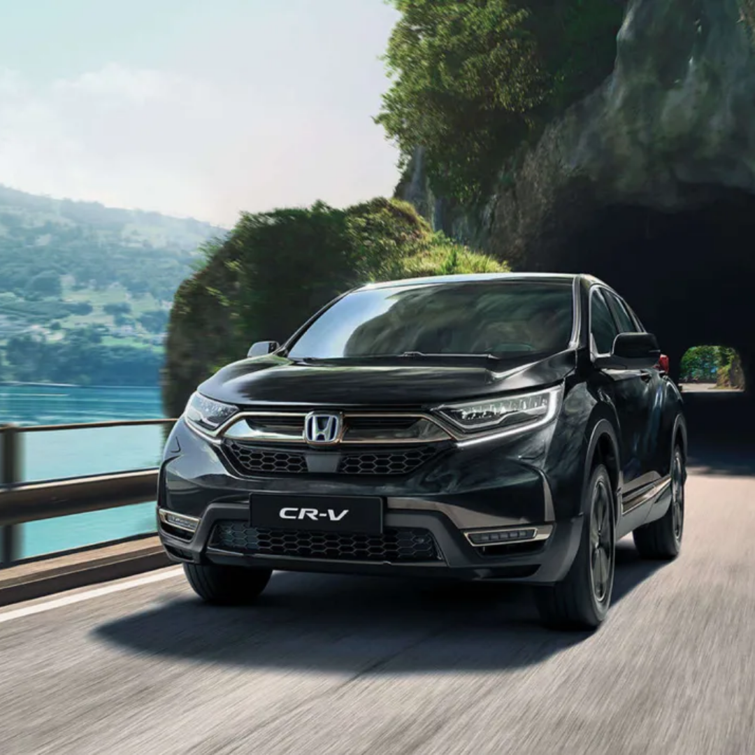 Black Honda CR-V front driving along a mountain road