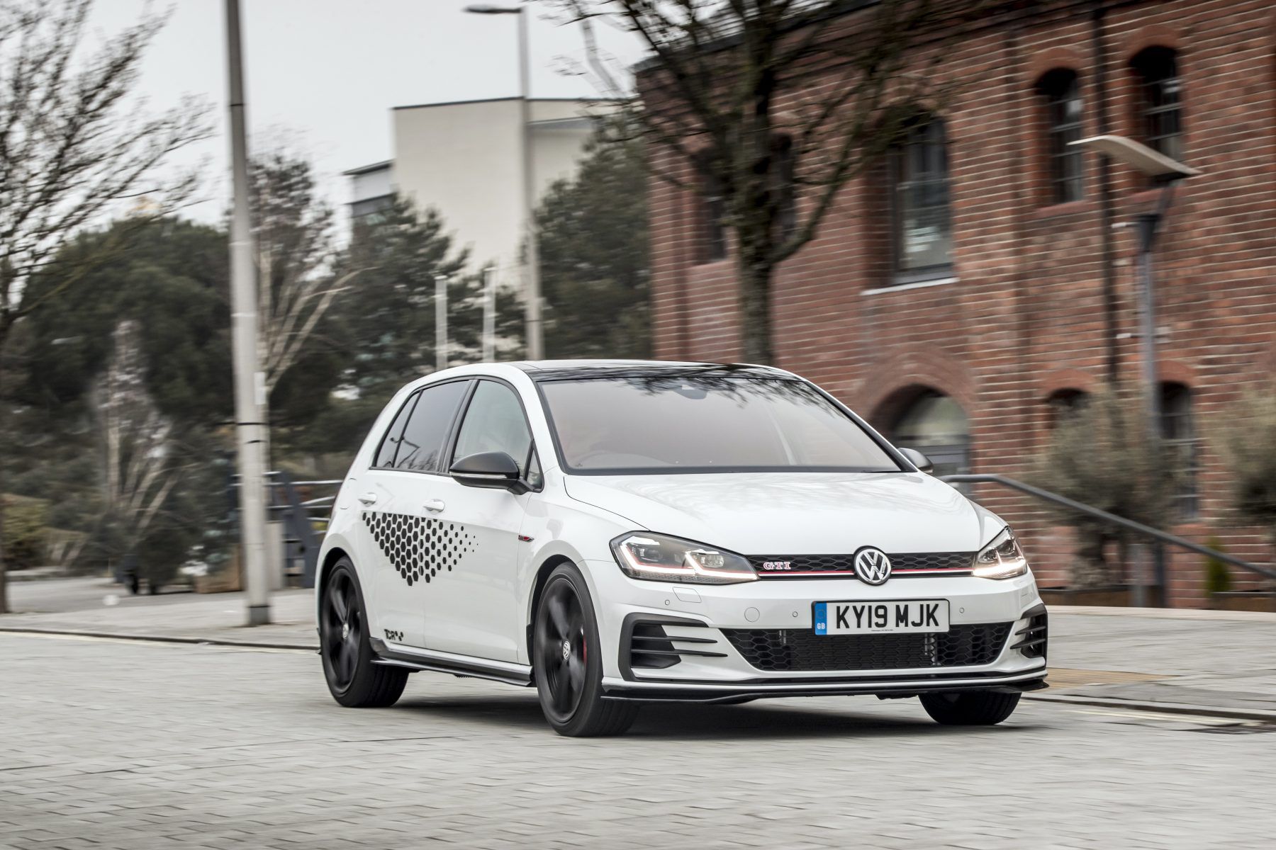Front view of a Volkswagen Golf GTI TCR driving down road