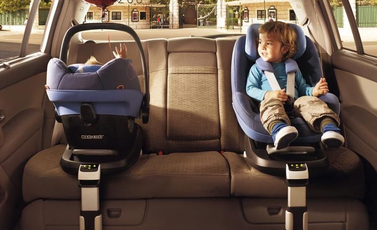 two children in car seats in a car