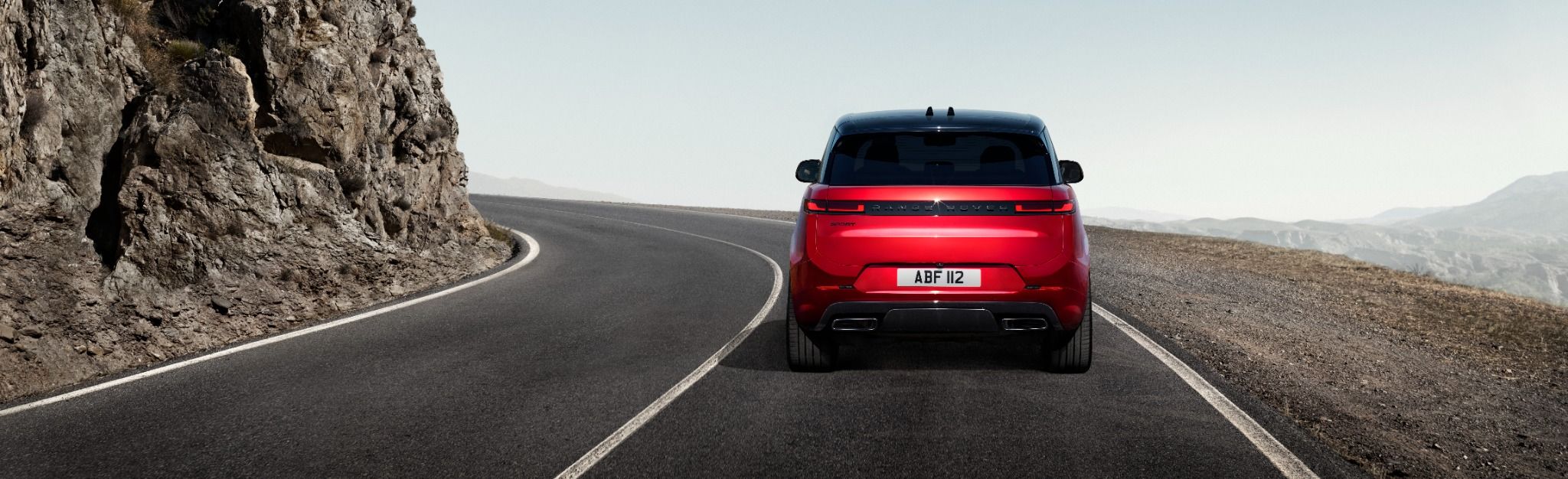 Rear view of Range Rover Sport driving on a road