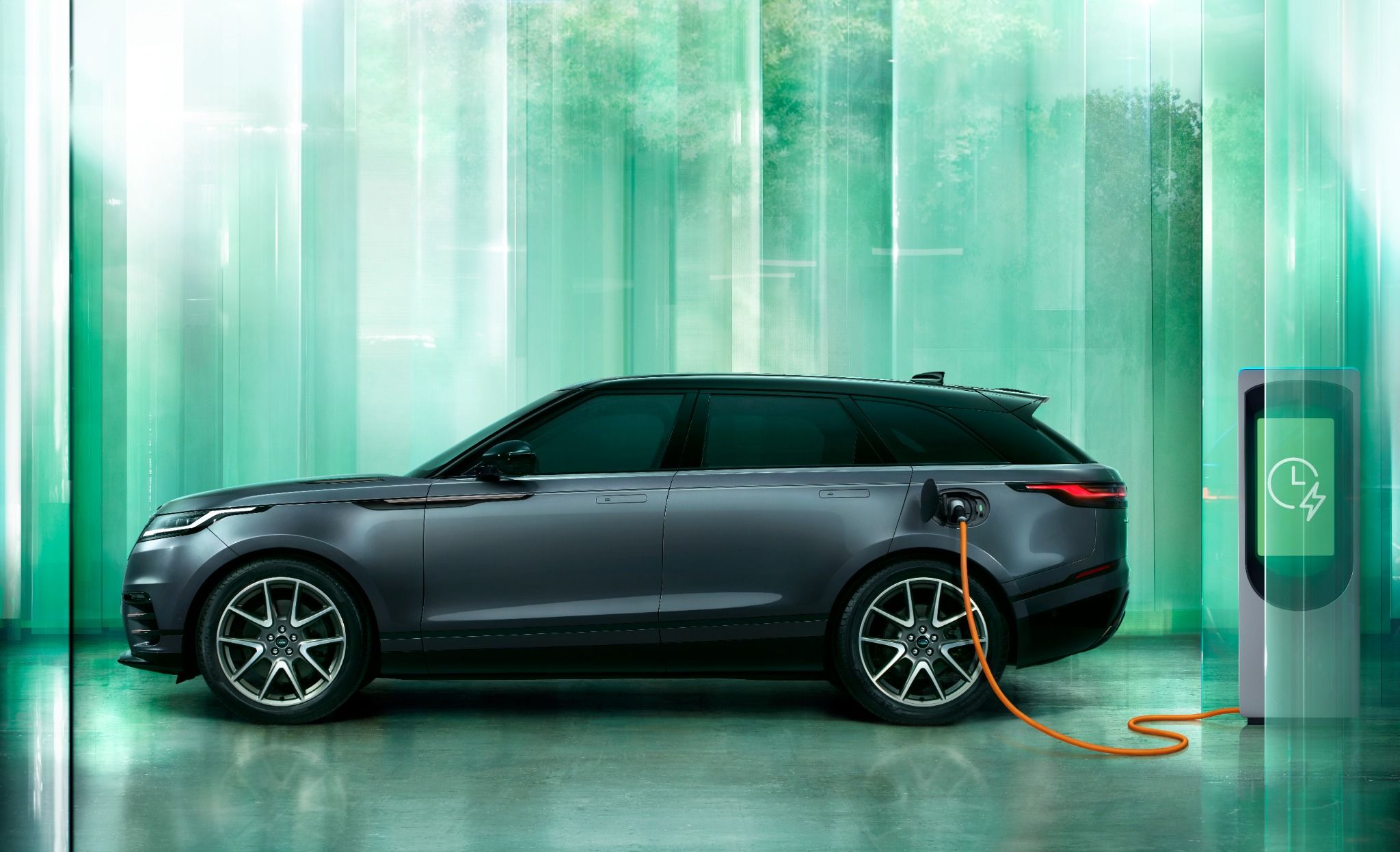 Side view of New Velar plugged into charger