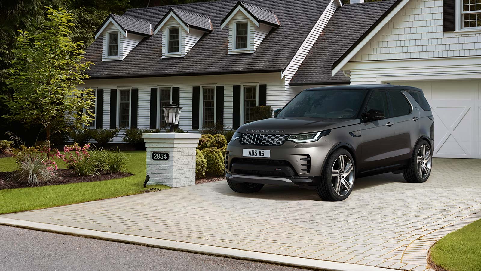 Grey Land Rover Discovery exterior front parked on a driveway