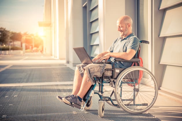 man on laptop in wheelchair
