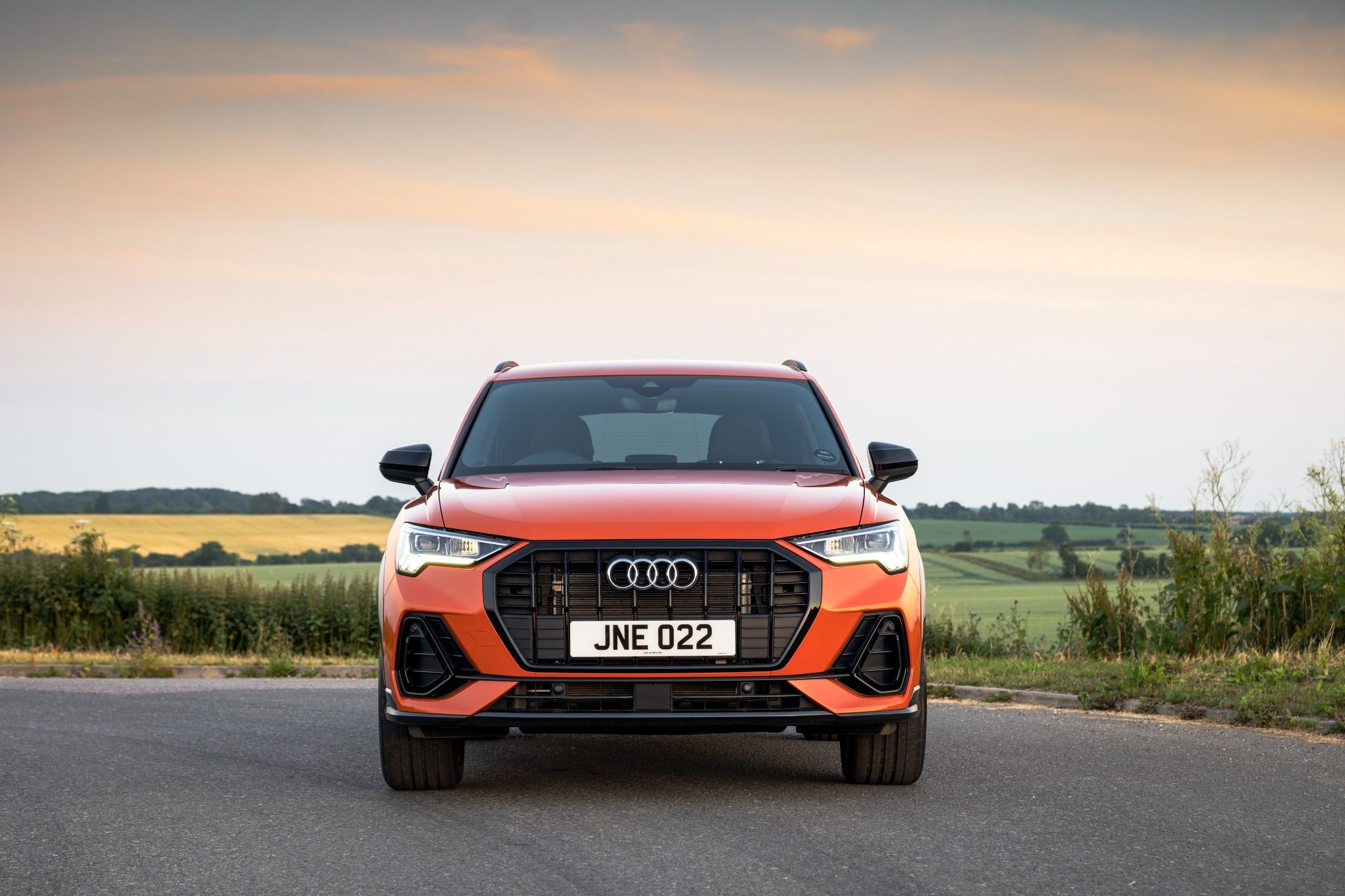 Orange Audi Q3 with field in background