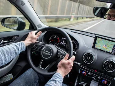 Interior Audi with person holding the steering wheel