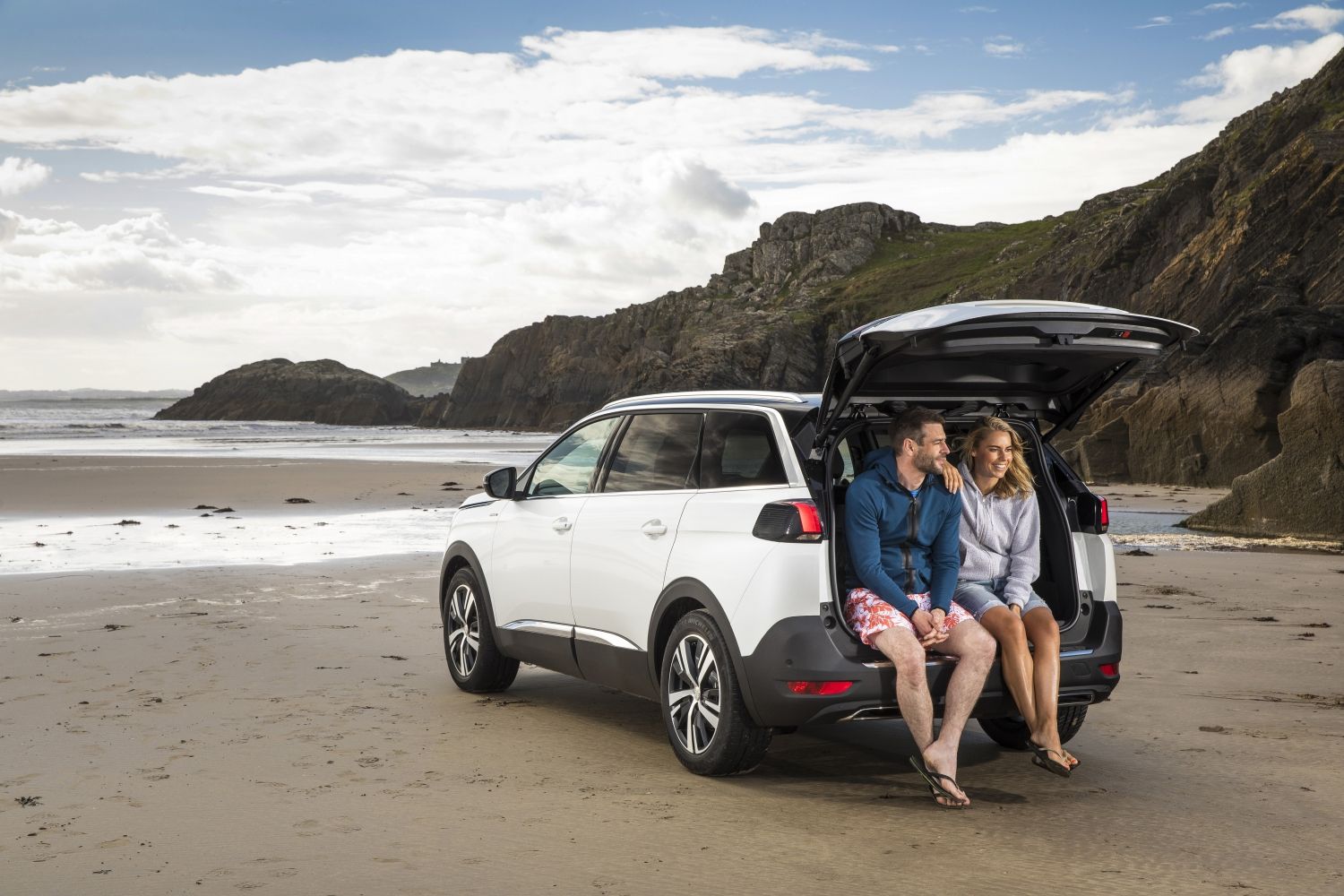Peugeot 5008 SUV couple sat in the boot