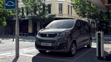 Grey Peugeot e Traveller parked and charging