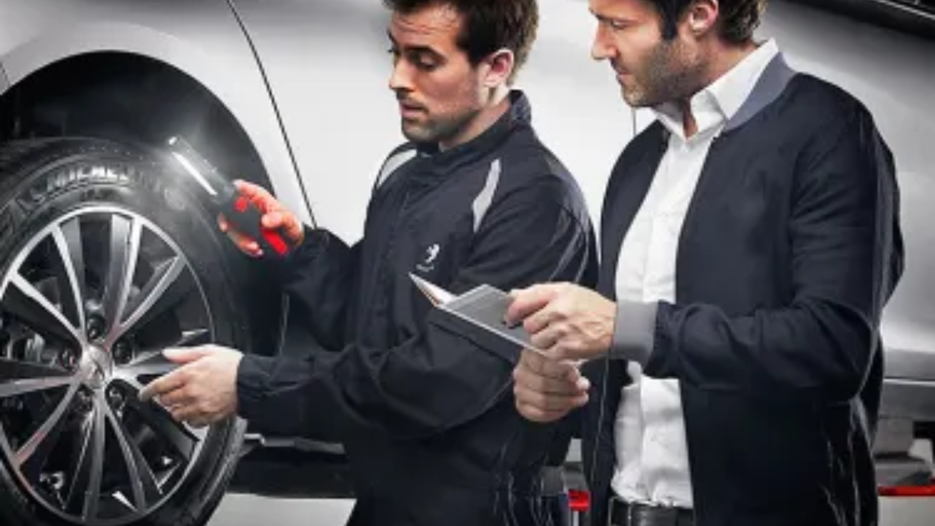 Image of service advisor and workshop technician carrying out service on Peugeot