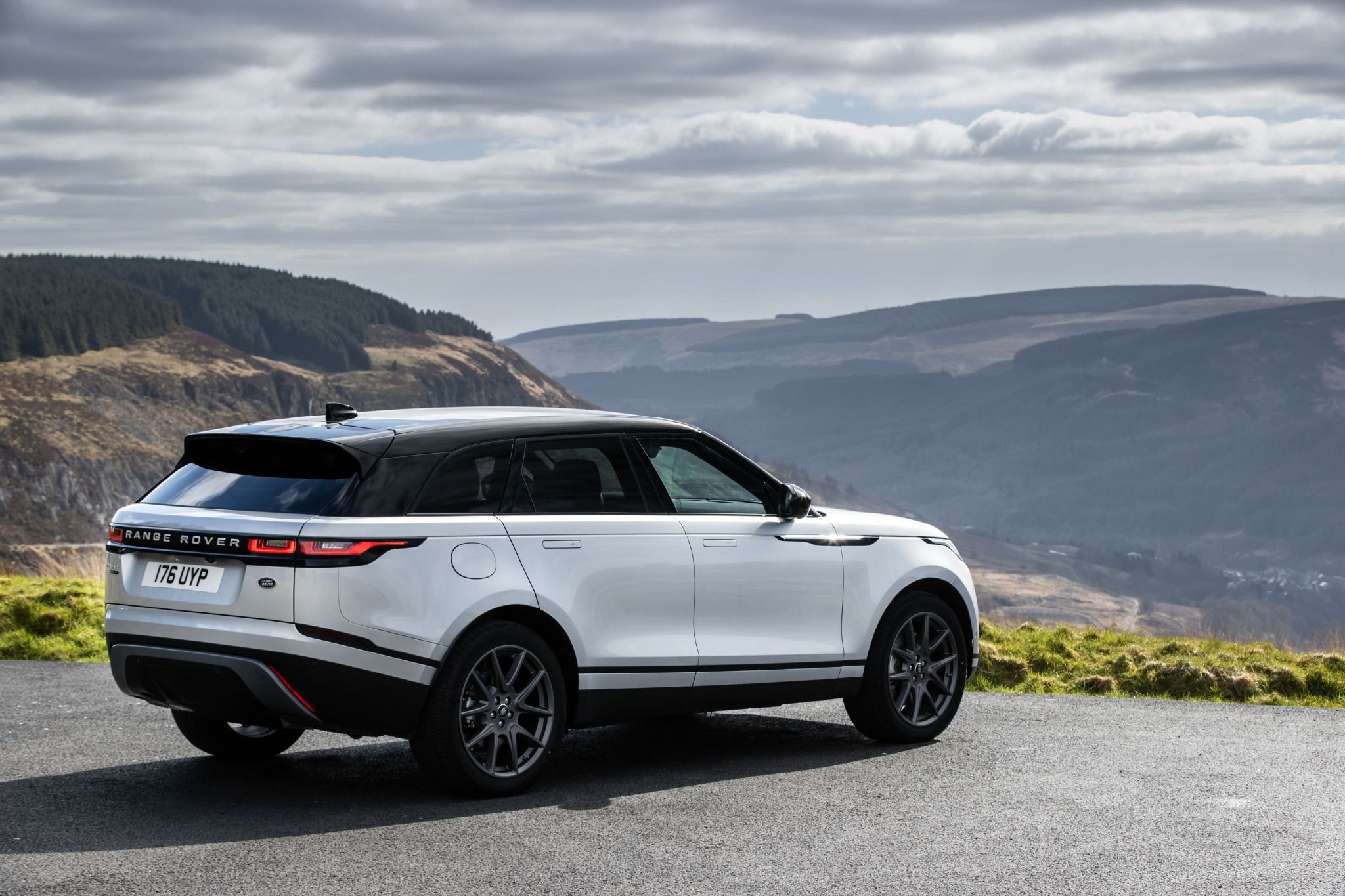 Rear view of a silver Range Rover Velar parked on a cliff