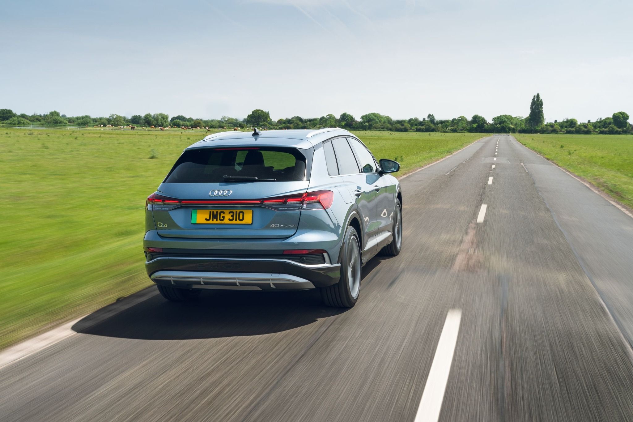 Grey Audi Q4 etron driving on the road