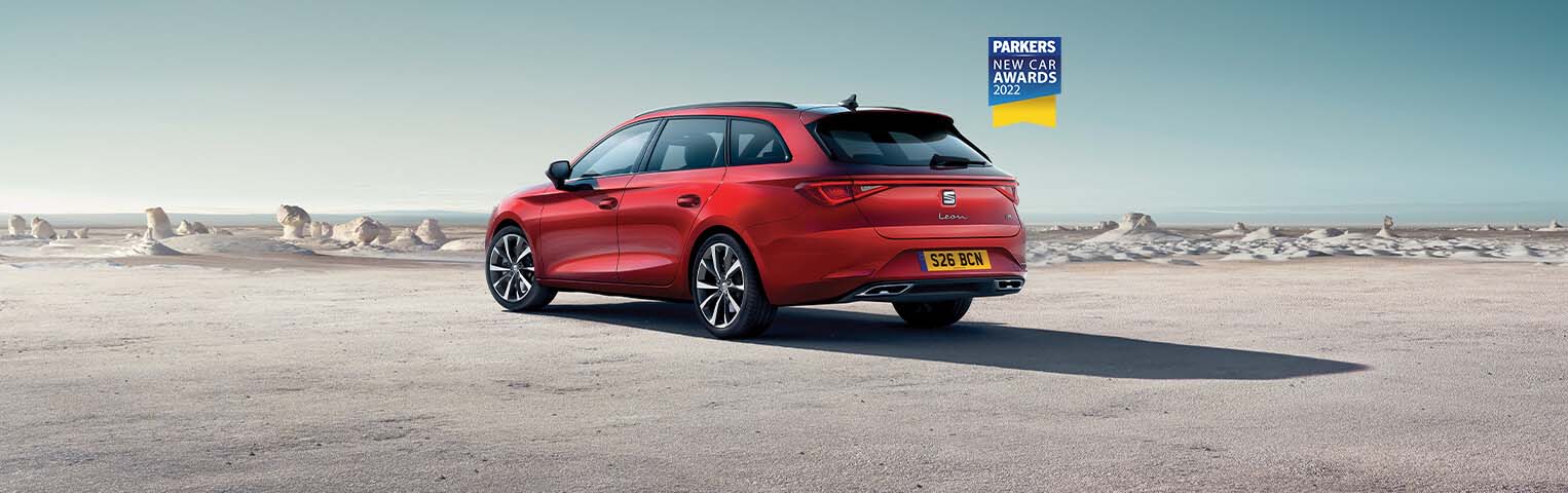 Red SEAT Leon estate exterior rear parked on sand