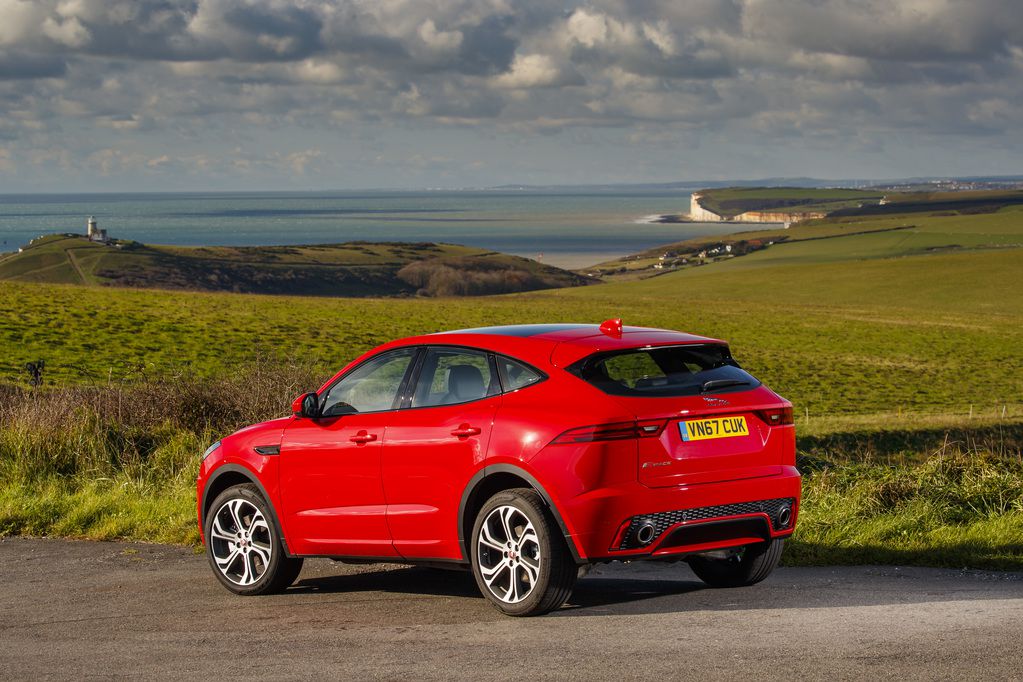 Rear view of red jaguar e pace in the countryside