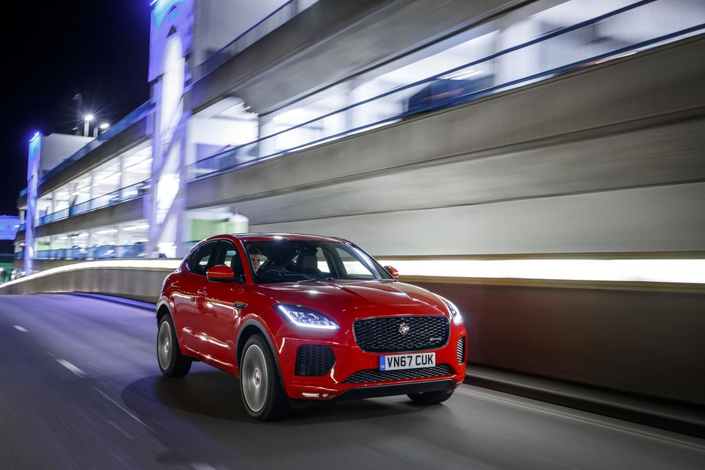 Red jaguar e pace driving at night
