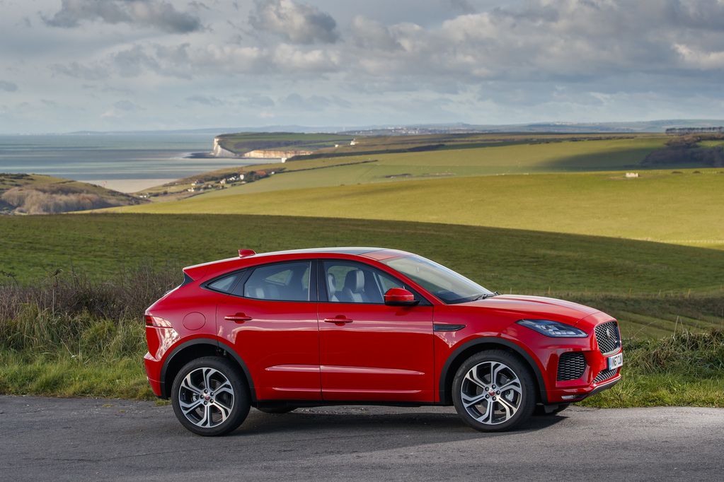 Red Jaguar E Pace side view in the countryside