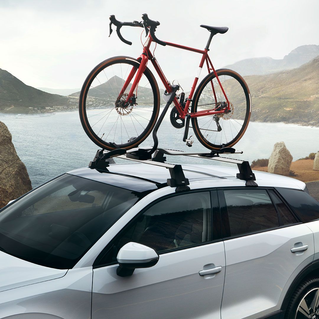 White Audi with roof bars and bike