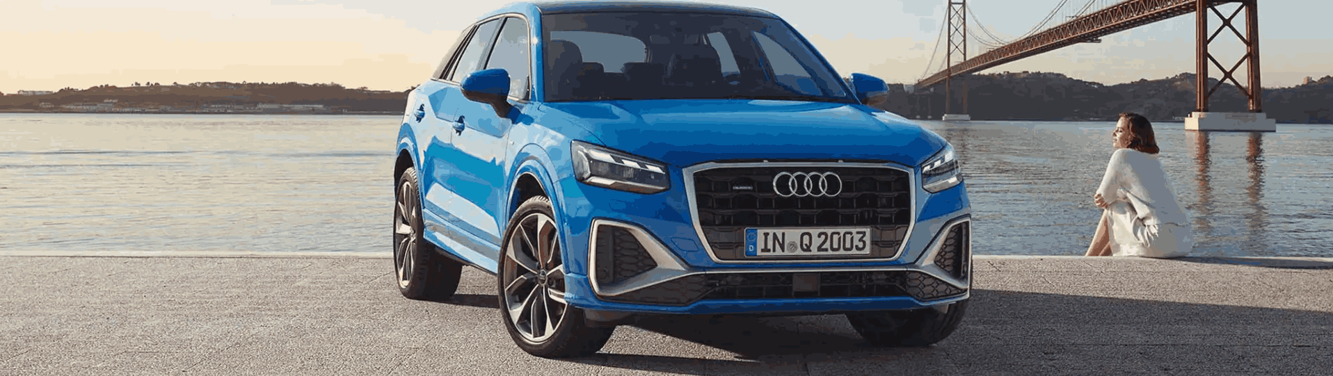 Blue audi in front of water