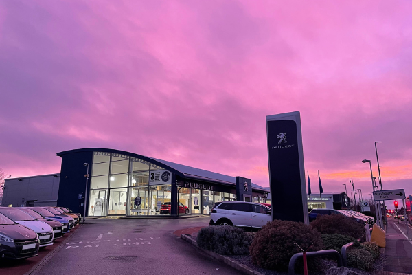 Swansway Chester Peugeot dealership exterior in the evening