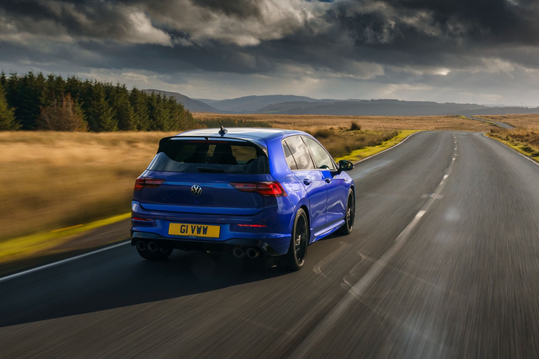 Rear view of Volkswagen Golf R driving on a road