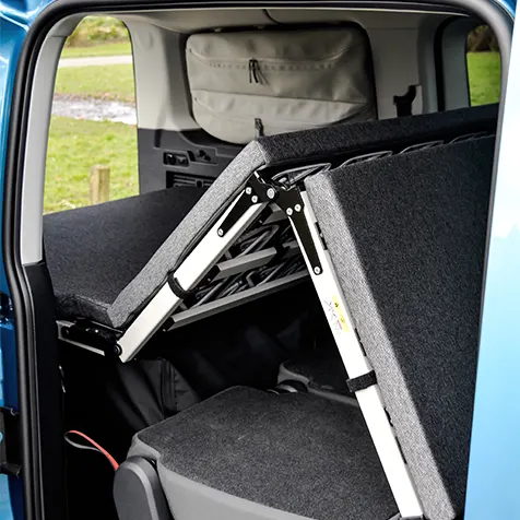 Blue Volkswagen Caddy California interior rear folding bed