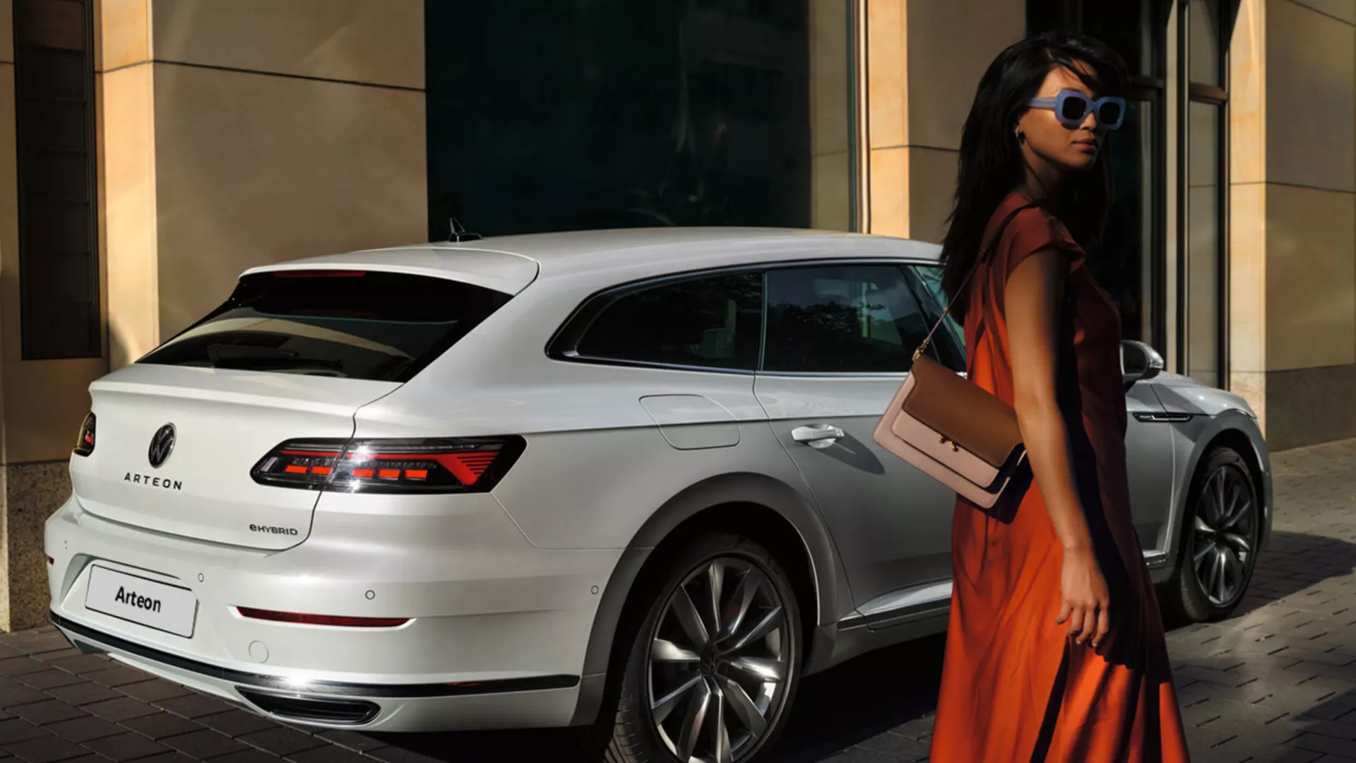 Woman stood next to a White Volkswagen Arteon Shooting Brake e-Hybrid